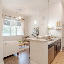 a kitchen and a living room with a couch