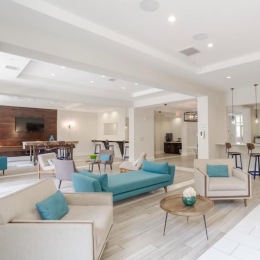 a clubroom with a couch and chairs