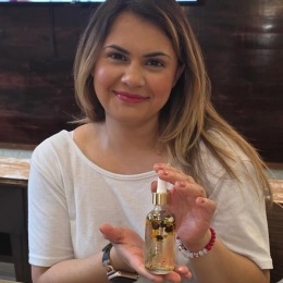 a woman holding a bottle of perfume