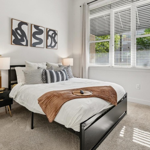a bedroom with a bed and a fan