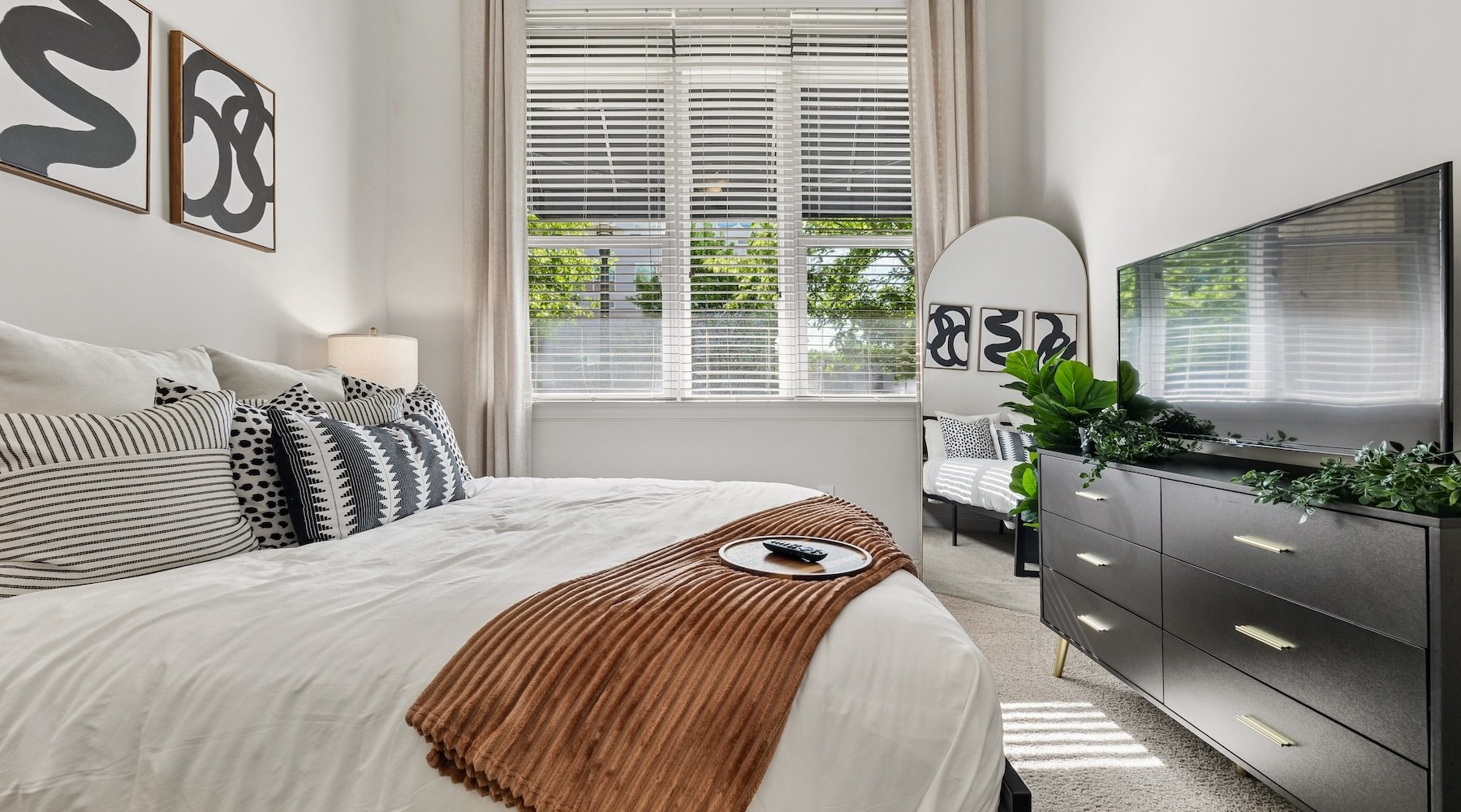 a bedroom with a bed and a tv