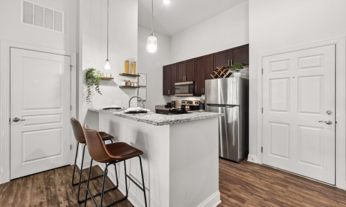a kitchen with a table and chairs